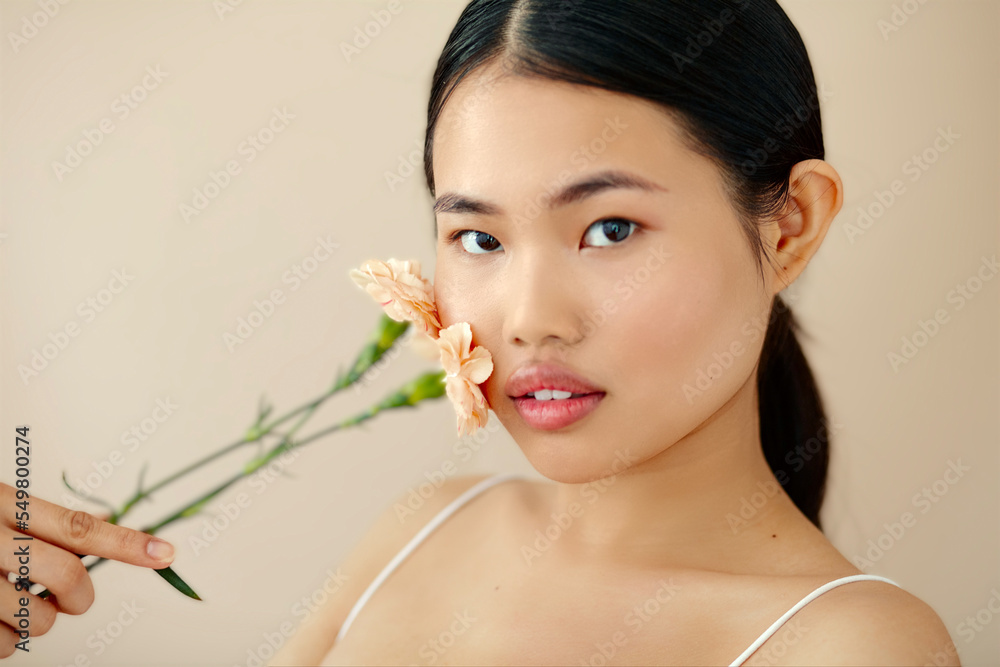 Asian Woman Posing In Studio. Woman With Flower. Body Care. Asian Woman Posing In Studio. Woman With Flower. Body Care.