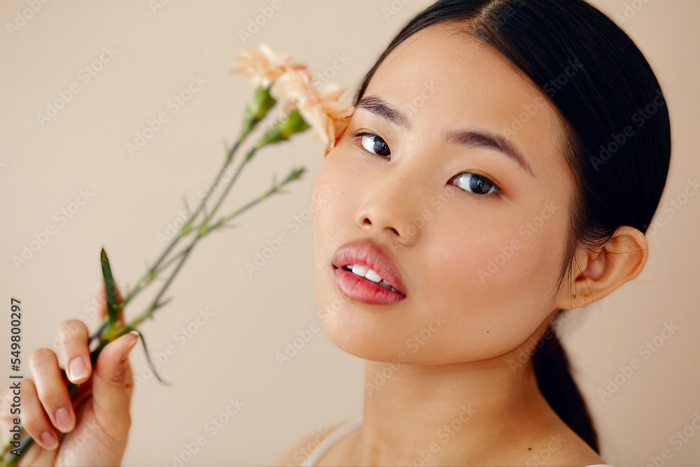 Asian Woman Posing In Studio. Woman With Flower. Body Care. Asian Woman Posing In Studio. Woman With Flower. Body Care.