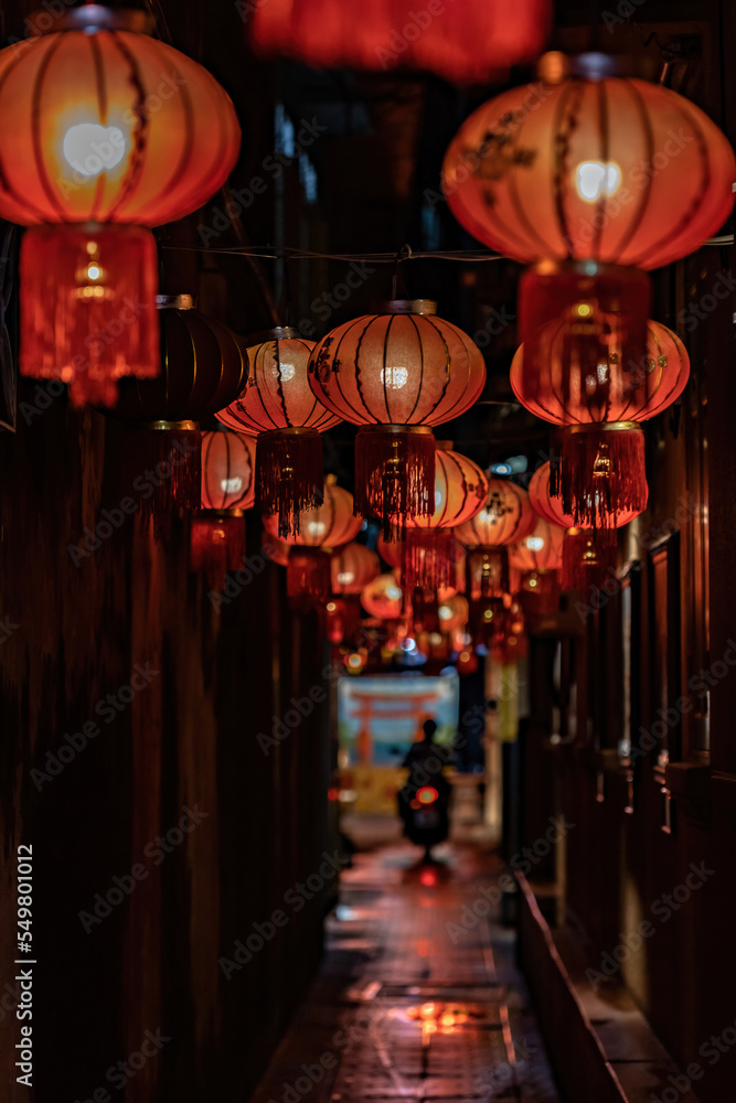 Naklejka premium Chinese lanterns on the street at night, China town, Chinese new year decoration. Translation: Happy New Year