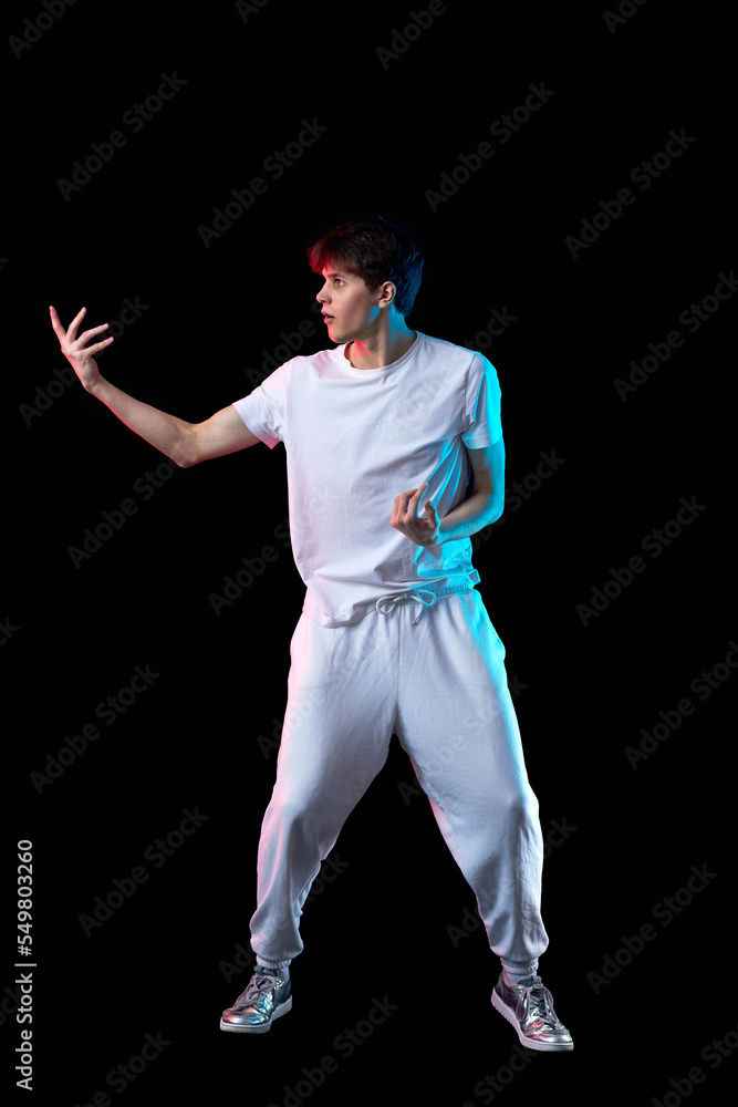 young man in black t-shirt and jeans dancing young man in black t-shirt and jeans dancing