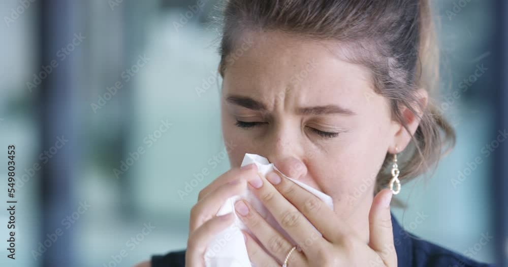 Blowing nose, flu and sick business woman in modern office, covid 19