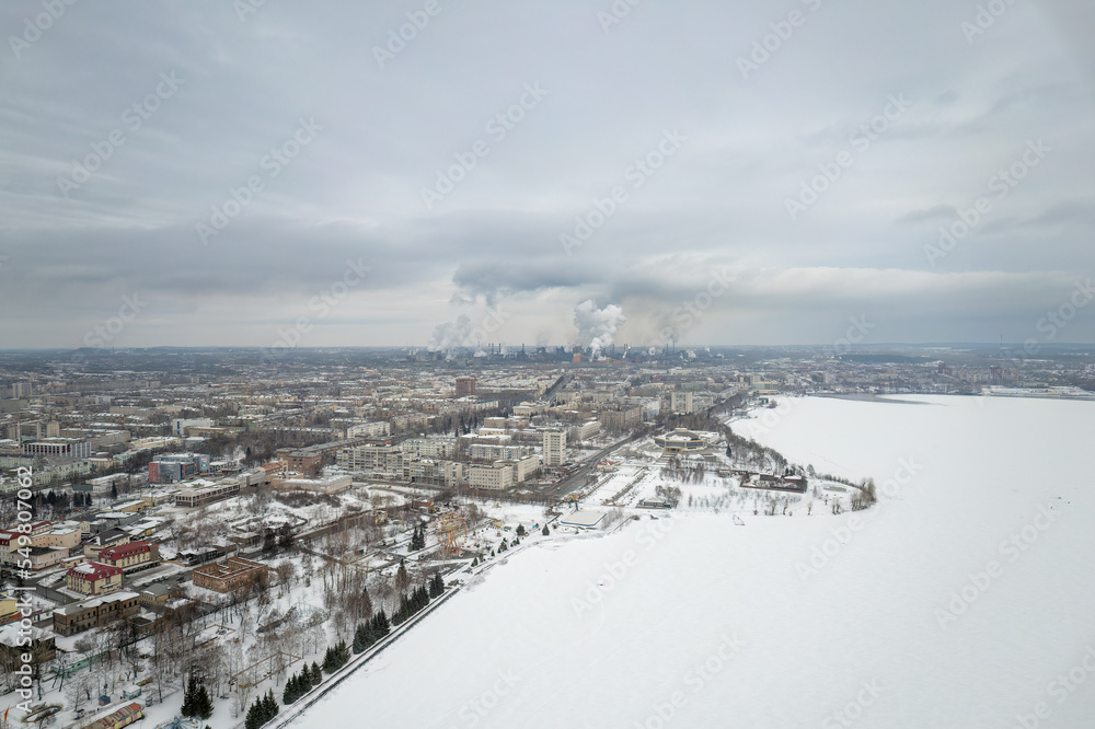 Winter view of the embankment of the city of Nizhny Tagil and the metallurgical plant from above. Environmental problem of environmental pollution and air in large cities