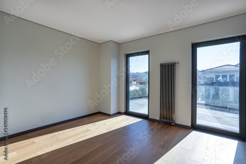 empty room in an apartment with two windows to the floor