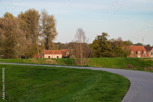 Berlare, East Flemish Region, Belgium, View over a bending cycling trail and the church tower