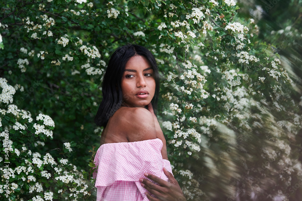 black woman amidst blooming branches black woman amidst blooming branches