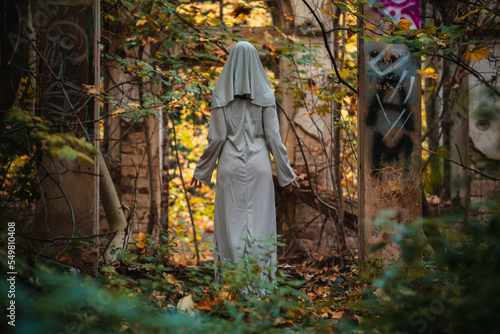 A creepy nun in a white dress.