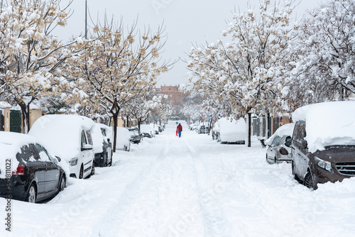 Snowy streets and cars covered with snow during a winter heavy blizzard, Torrejon de Ardoz, Madrid, Spain