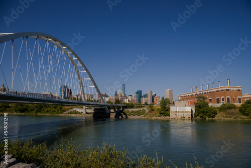 Modern arc bridge over the river, day traffic, summer time. modern architecture, panorama of the city Edmonton