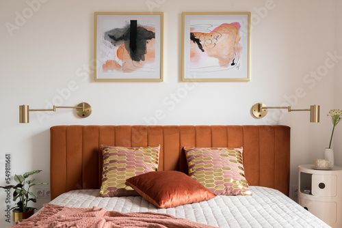 Tableau sur toile Elegant bedroom with bed with velvet headboard