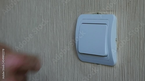 The electrician installs the circuit breaker with a screwdriver.