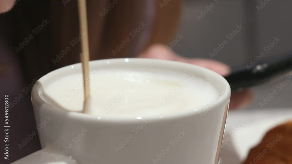 Stirring Thick Foam Of Hot Coffee With Spoon In a Cup. Stirring Thick Foam Of Hot Coffee With Spoon In a Cup.