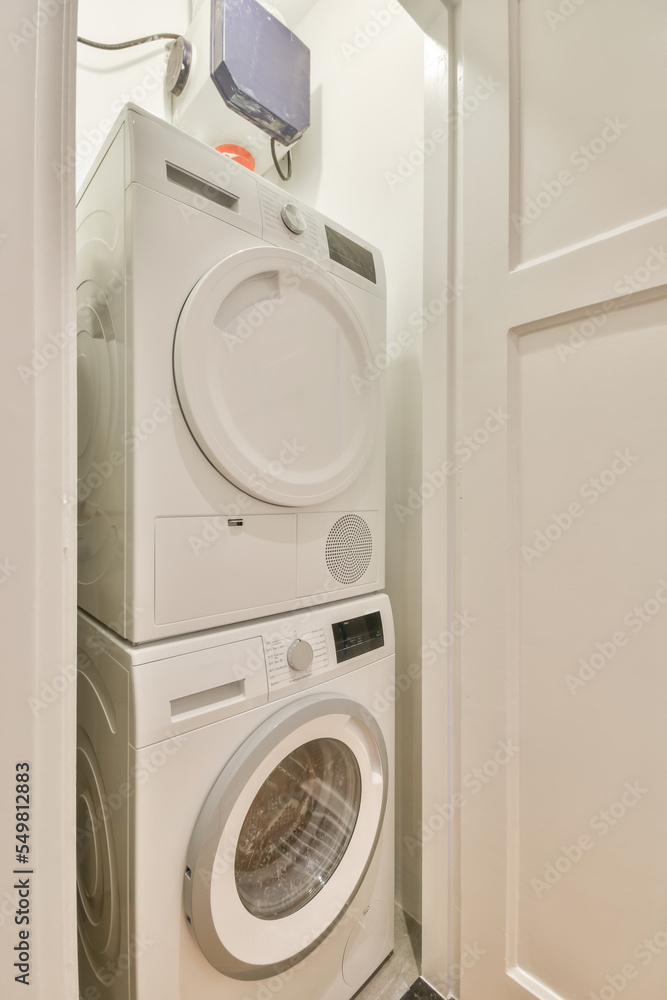 Washing and dryer machine in contemporary bathroom with white walls Washing and dryer machine in contemporary bathroom with white walls