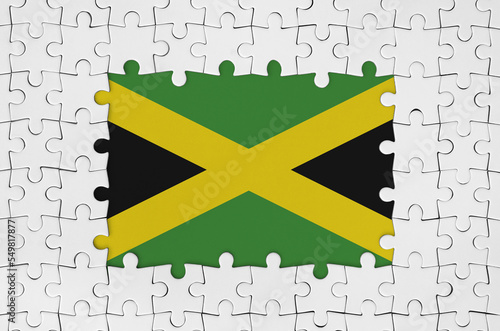 Jamaica flag in frame of white puzzle pieces with missing central part photo