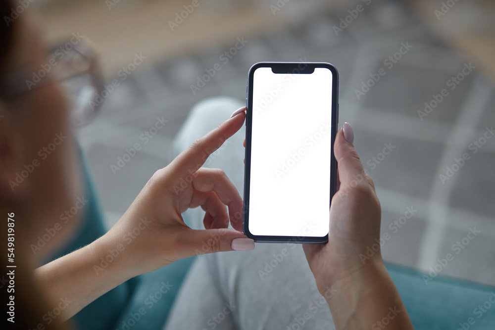 Mock up white screen blank mobile phone in woman hands holding Back view