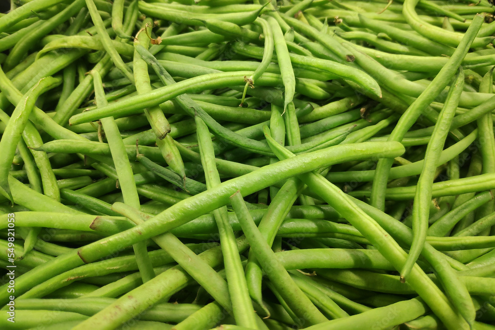 Stack of green beans on a market stall Stack of green beans on a market stall