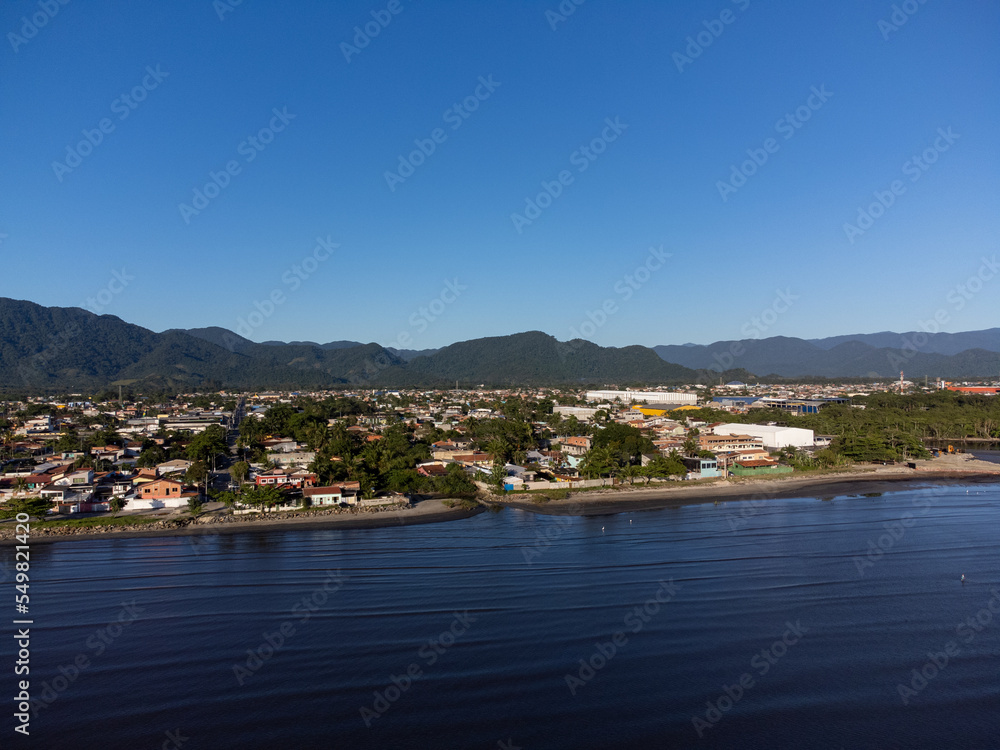 quiet beach with flowing river and small coastal town