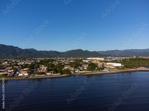 quiet beach with flowing river and small coastal town