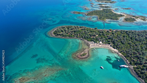 Aerial drone photo of tropical exotic paradise volcanic island complex bay with deep turquoise sea forming a blue lagoon archipelago visited by luxury yachts and sail boats