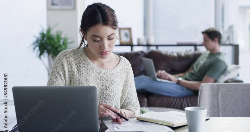 Woman, laptop and working on documents in living room at home, remote worker and finance report planning. Accounting, entrepreneur and couple manage home mortgage, savings payment or banking strategy Woman, laptop and working on documents in living room at home, remote worker and finance report planning. Accounting, entrepreneur and couple manage home mortgage, savings payment or banking strategy