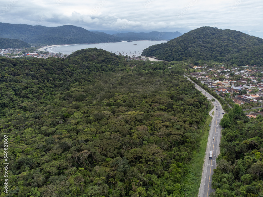 small road leading to the beach in a fishing village in the middle of the mountains small road leading to the beach in a fishing village in the middle of the mountains