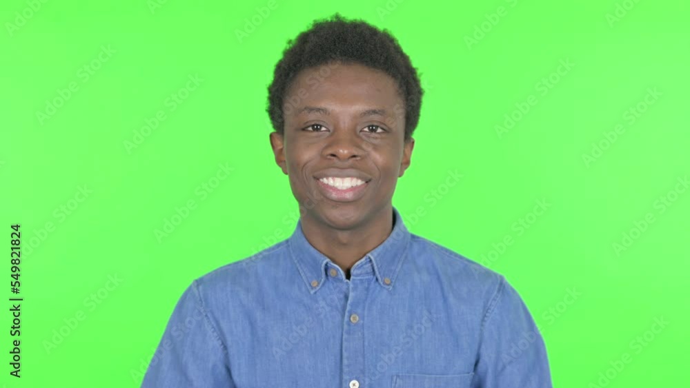 Pointing Young African Man Inviting on Green Background Pointing Young African Man Inviting on Green Background