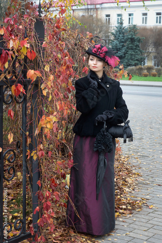 Young woman in vintage clothes on a walk in autumn day.