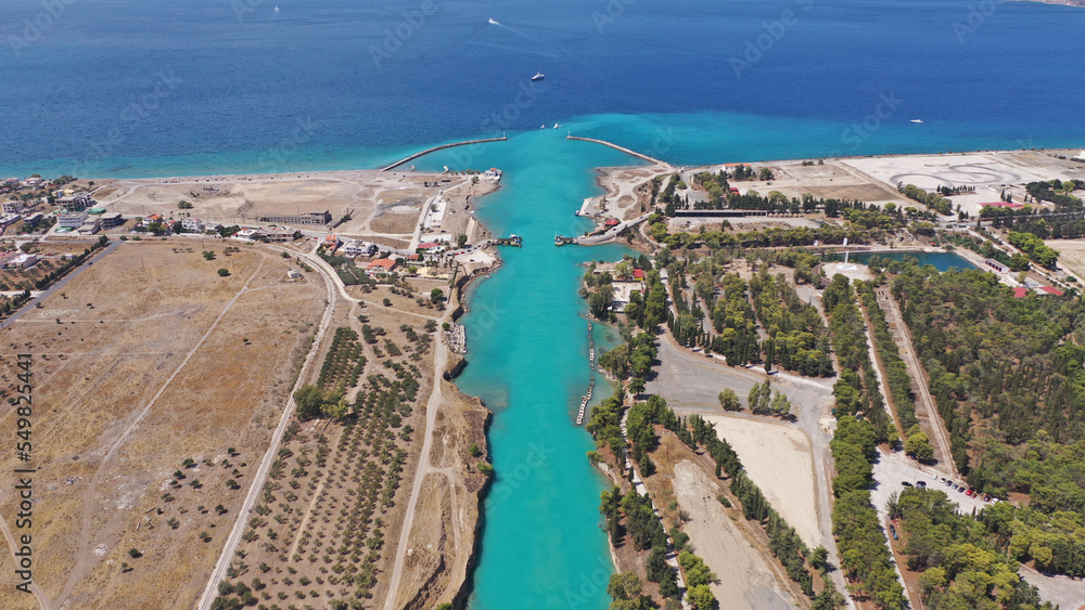 Aerial drone photo of yacht crossing narrow Corinth canal of Isthmus from West submersible bridge and narrow opening of Corinthian gulf to Saronic gulf, Loutraki, Greece