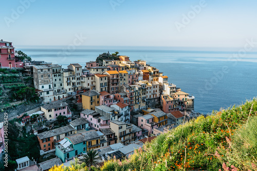 Aerial view of Manarola,Cinque Terre,Italy.UNESCO Heritage Site.Picturesque colorful village on rock above sea.Summer holiday,travel background.Italian Riviera landscape.Houses on steep cliff