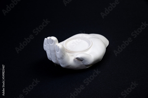candlestick in the form of a plaster hand with candles, a plaster candlestick in the shape of a stone. tea candle. interior candle holder with your own hands