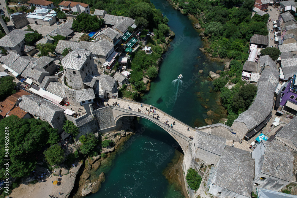 Fantastic Skyline of Mostar with the Mostar Bridge, houses and minarets, during sunny day. Mostar, Old Town, Bosnia and Herzegovina, Europe
