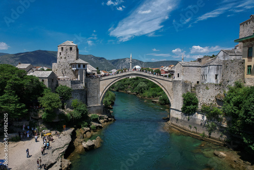 Fantastic Skyline of Mostar with the Mostar Bridge  houses and minarets  during sunny day. Mostar  Old Town  Bosnia and Herzegovina  Europe