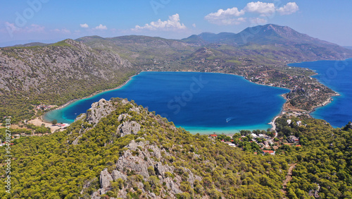 Fototapeta Naklejka Na Ścianę i Meble -  Aerial drone photo of scenic lake Vouliagmeni in Corinthia near famous lighthouse of Heraion and city of Loutraki featuring crystal clear turquoise beach and calm waters, Perachora, Greece