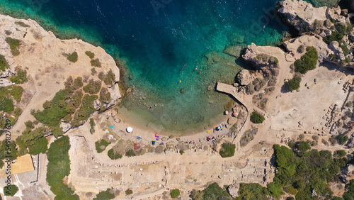 Aerial drone photo of famous archaeological site of Heraion in Cape Melagavi featuring a small beach next to iconic lake Vouliagmeni and lighthouse, Corinthian bay, Perachora, Loutraki, Greece photo