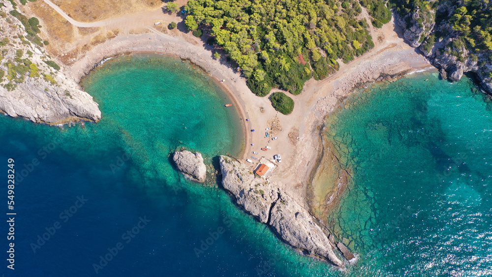 Aerial drone top down photo of scenic half moon shaped crystal clear sea beach of Milokopi near famous lake Vouiagmeni, Loutraki, Perachora, Greece