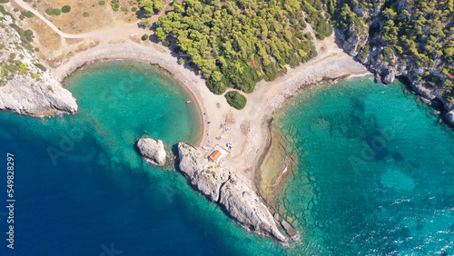 Aerial drone top down photo of beautiful half moon beach in tropical exotic island bay with deep turquoise sea
