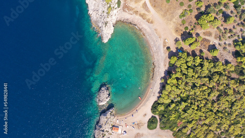 Aerial drone top down photo of scenic half moon shaped crystal clear sea beach of Milokopi near famous lake Vouiagmeni, Loutraki, Perachora, Greece © aerial-drone