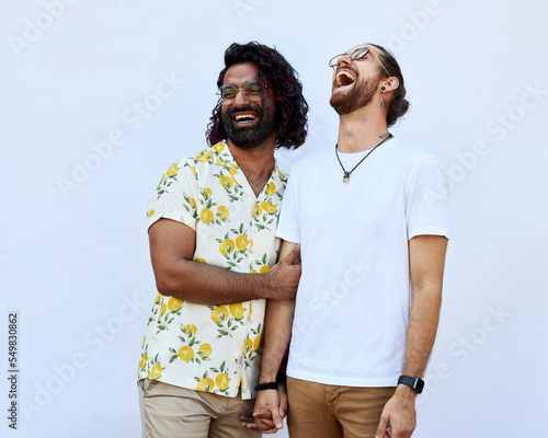 Portrait of Male LGBTQ+ couple laughing on a white background