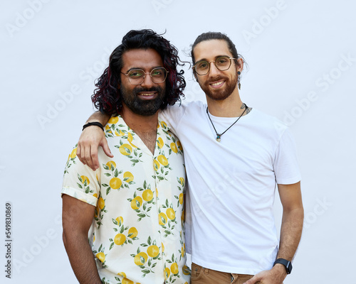 Portrait of Male LGBTQ+ couple smiling to camera on a white background