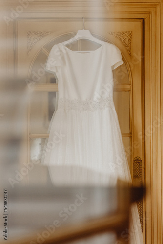 Robe de mariée suspendue sur la porte de la chambre