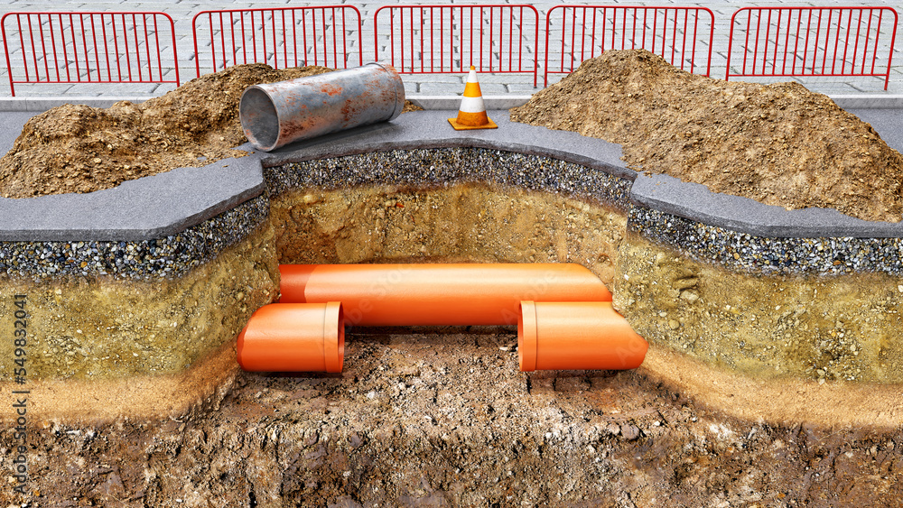 Obraz premium Concept of road works and underground pipes renovation, new orange pvc pipes are installed instead of old rusty section, slice of ground and a pit digged in the asphalt, mounds of soil are upside