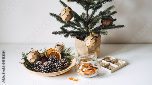 Sustainable Eco friendly zero waste Christmas. Natural Zero waste sustainable Xmas Tree Ornament Hanging Decorations. Christmas Tree and dry orange Slices, snow Pine Cones Ornament on table