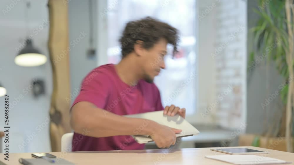African Man Leaving Office after Closing Laptop African Man Leaving Office after Closing Laptop