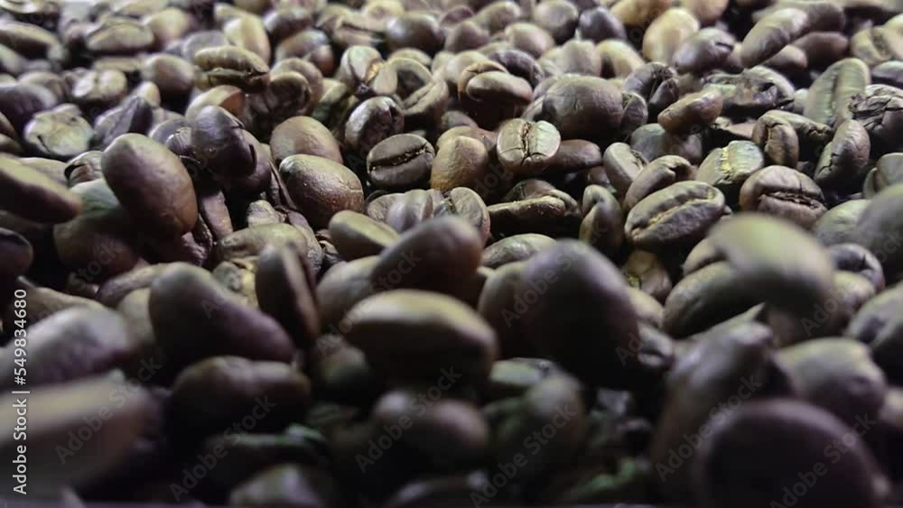 Super close-up of freshly roasted coffee beans bouncing on the coffee texture Super close-up of freshly roasted coffee beans bouncing on the coffee texture