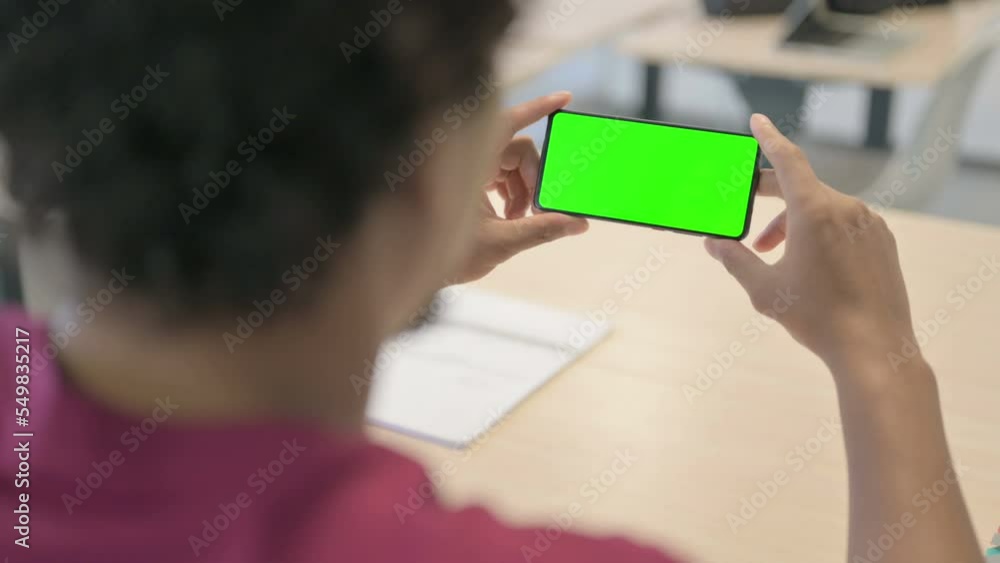 Close Up of African Man Watching Smartphone with Green Screen Close Up of African Man Watching Smartphone with Green Screen