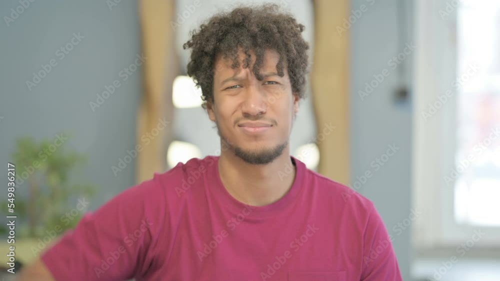 Portrait of African Man showing Thumbs Down Portrait of African Man showing Thumbs Down