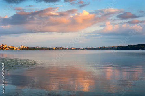 landscape with lake water and beautiful clouds in the evening sky of Ternopil...