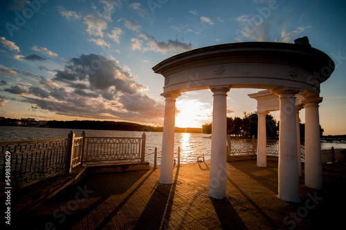 Arch with columns on the lake embankment in the evening at sunset, Ternopil, ...