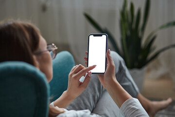 Woman hand holding using touch mobile phone white screen mockup Back view
