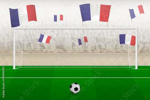 France football team fans with flags of France cheering on stadium, penalty kick concept in a soccer match.