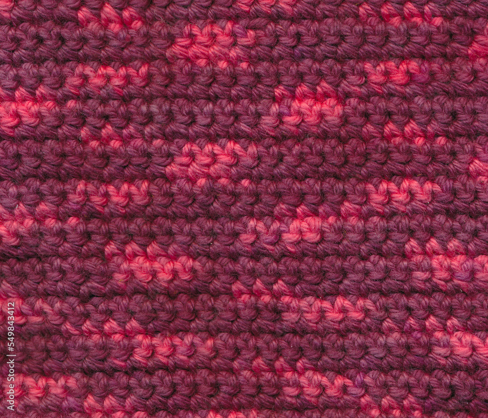 Fabric crocheted with red and pink cotton yarn, close-up background. Fabric crocheted with red and pink cotton yarn, close-up background.